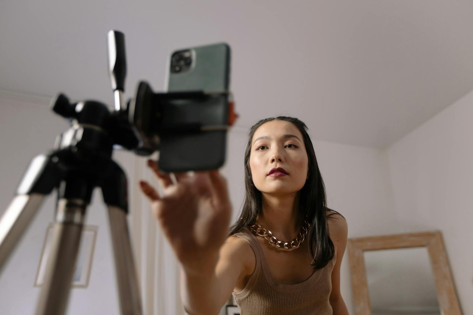 a woman in brown tank top taking a video