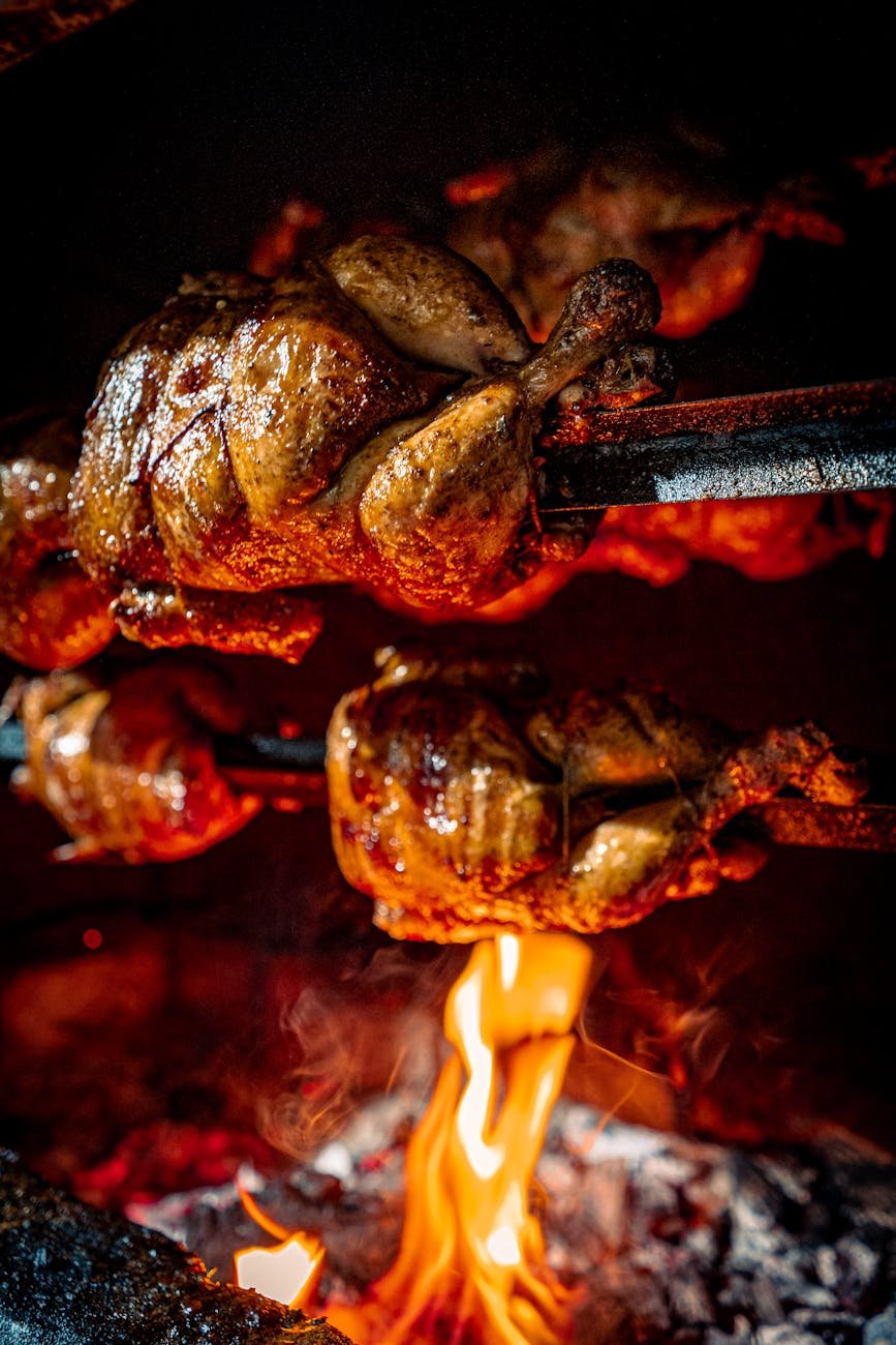 close up shot of roasted chickens in the rotisserie