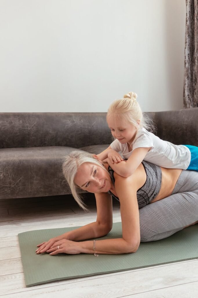 a woman doing exercise with her grandchild