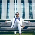 man wearing white suit jacket and white pants