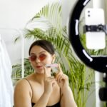 a woman holding a cosmetic product