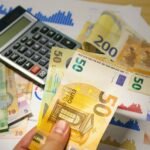 euro and lei banknotes with calculator on desk
