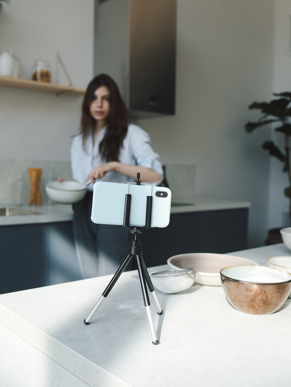 woman recording herself while cooking