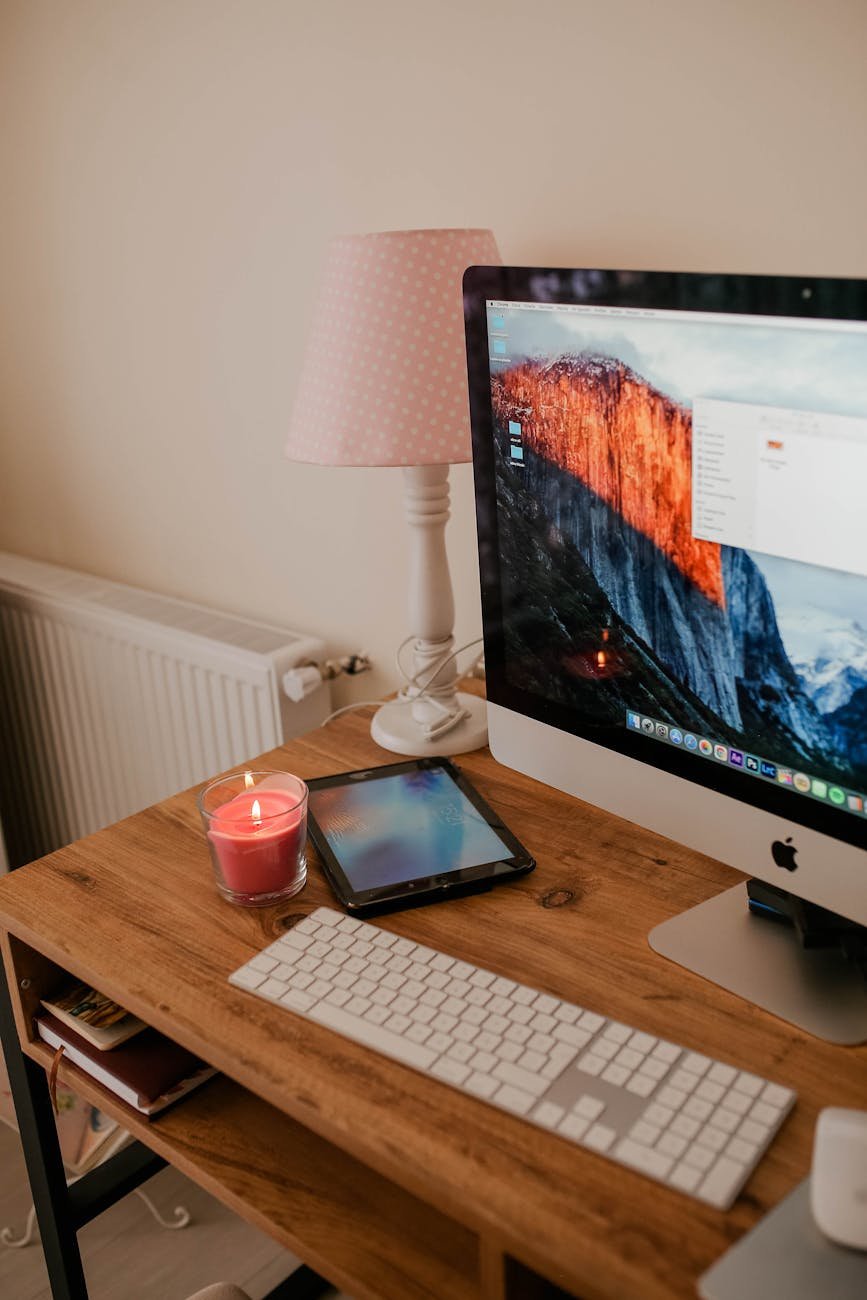 apple computer on a wooden desk