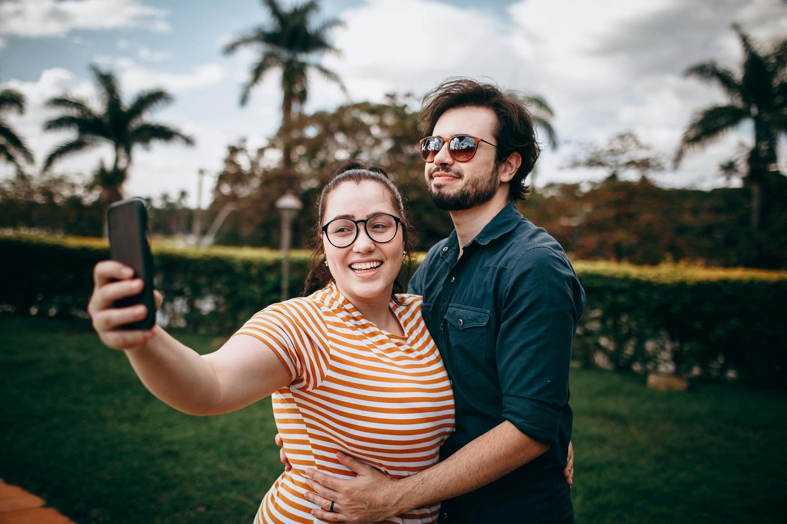 couple taking a selfie outdoors on a sunny day