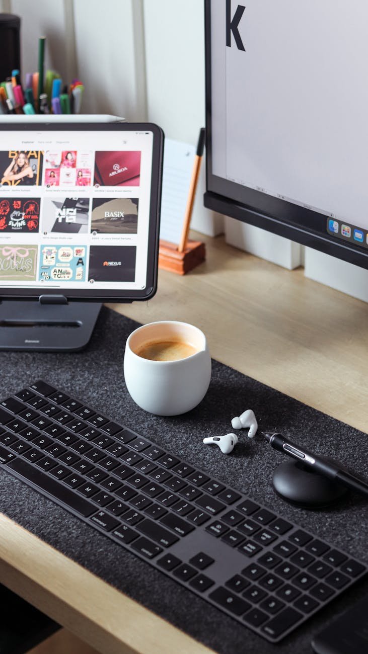 a desk with a keyboard mouse and coffee cup