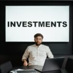 man in white long sleeve shirt sitting in front of black laptop