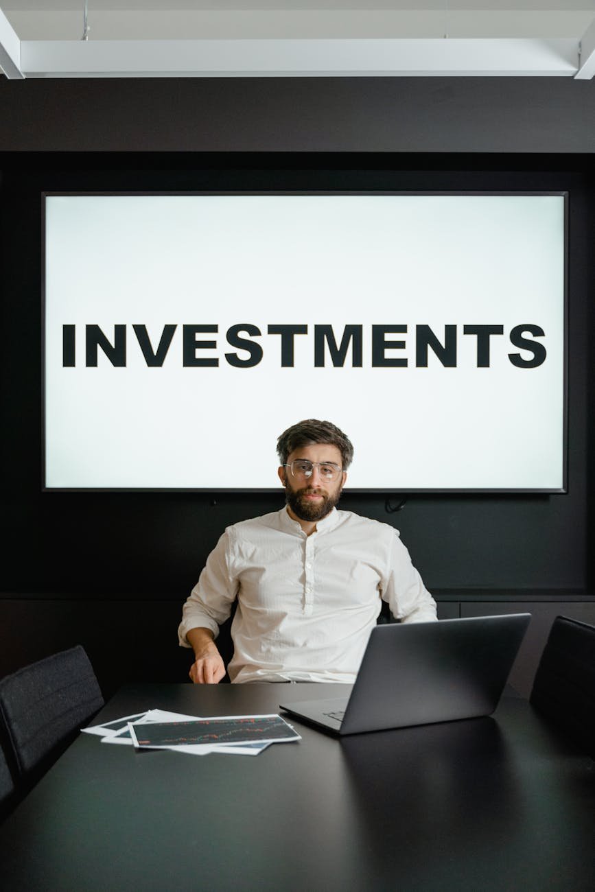 man in white long sleeve shirt sitting in front of black laptop