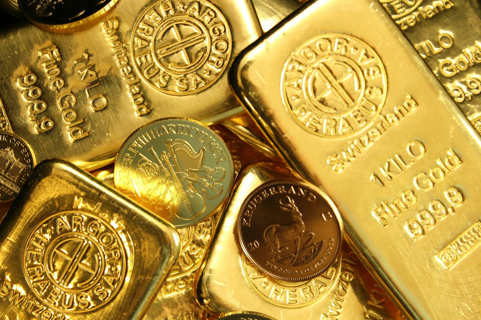 close up shot of gold bars and coins