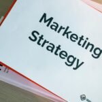 binders with marketing materials on table