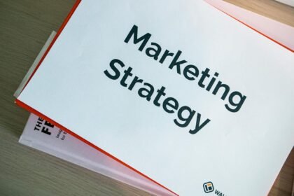 binders with marketing materials on table