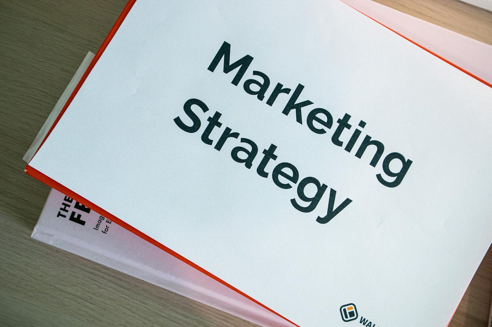 binders with marketing materials on table