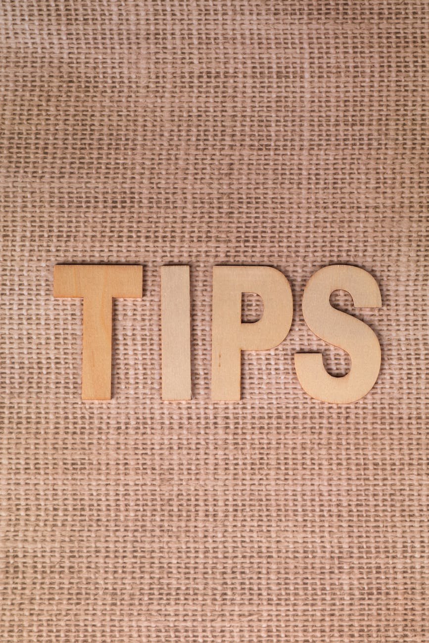 wooden letters forming tips on burlap background