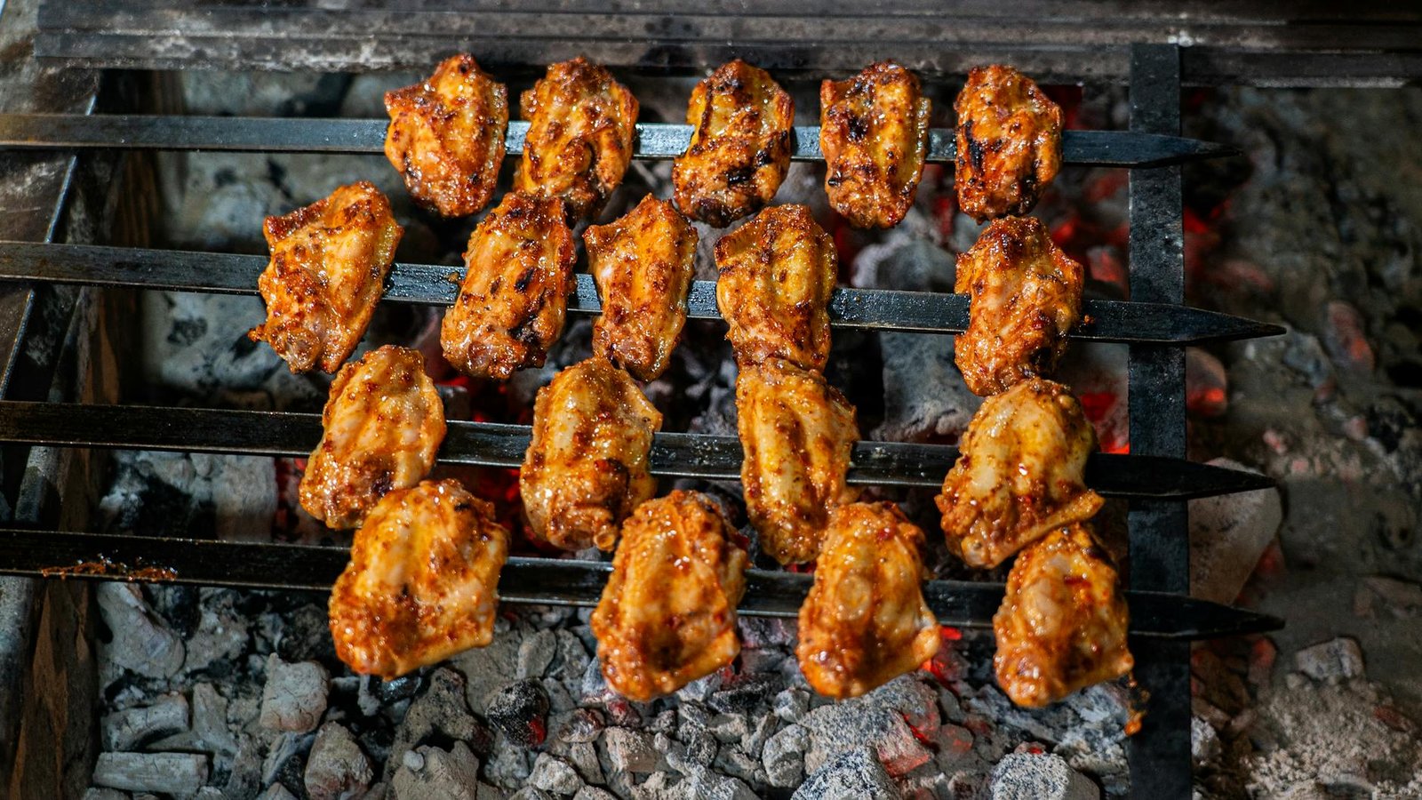 delicious grilled chicken skewers over charcoal