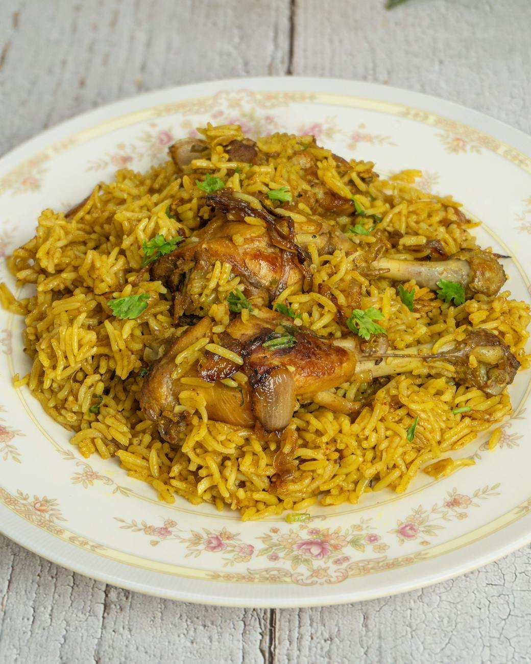 delicious chicken biryani on floral plate