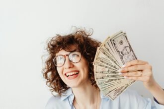 a woman holding us dollar bills